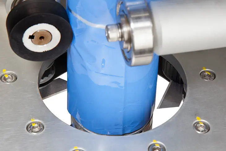 A blue component of a shrink sleeve labeler