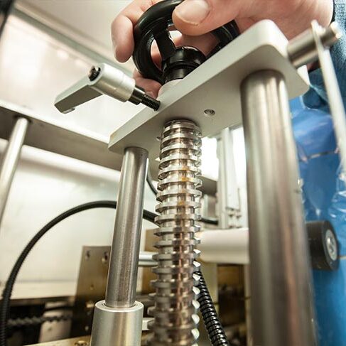 A person using a shrink sleeve machine